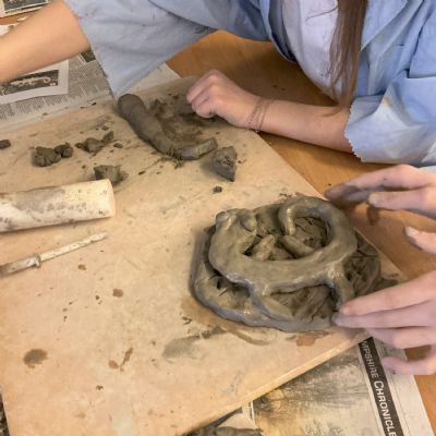 Children making clay lizards